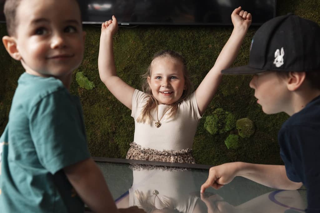 3 kinder spielen am 4touch spieletisch