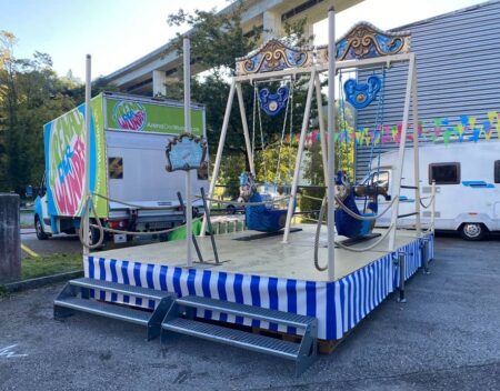 2er schiffschaukel in blau weiss auf einem festgelände.